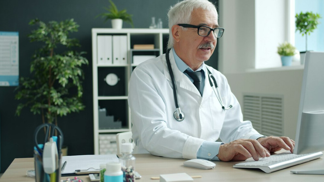 healthcare worker studying on laptop