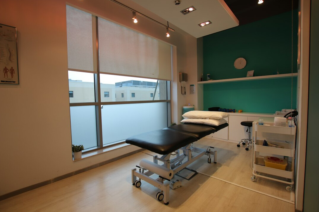 Physiotherapy room with treatment bed and resistance bands