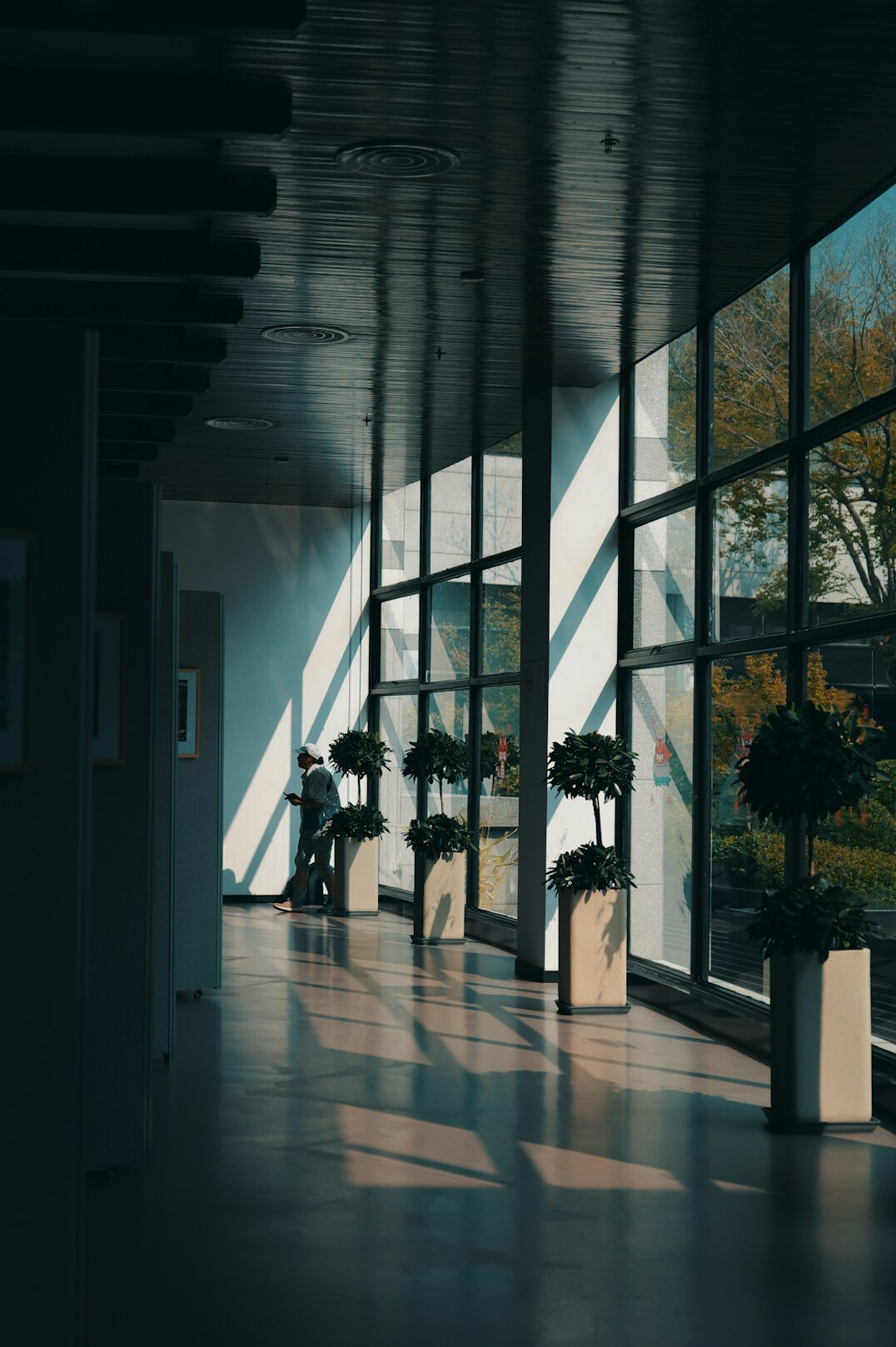 Three healthcare professionals standing together in a bright hallway