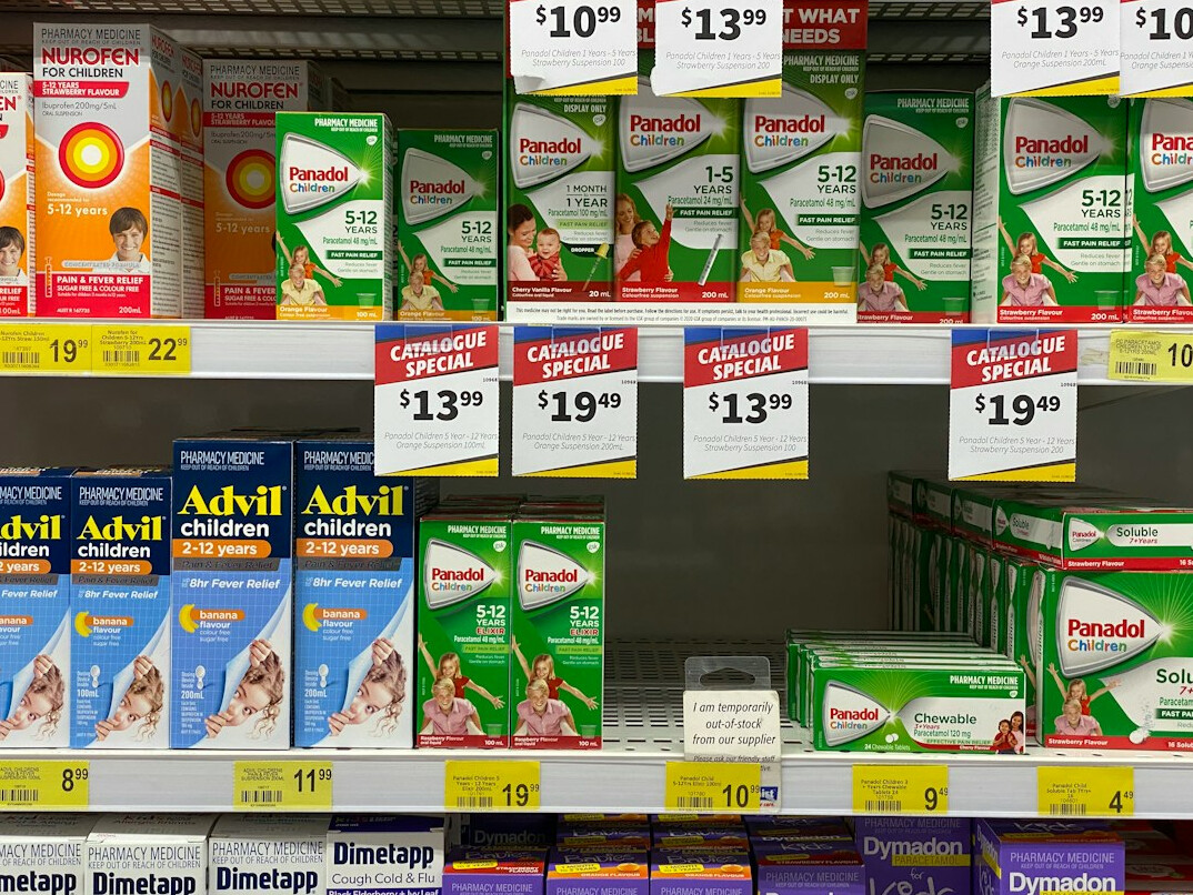 Organized pharmacy shelves with medicine boxes