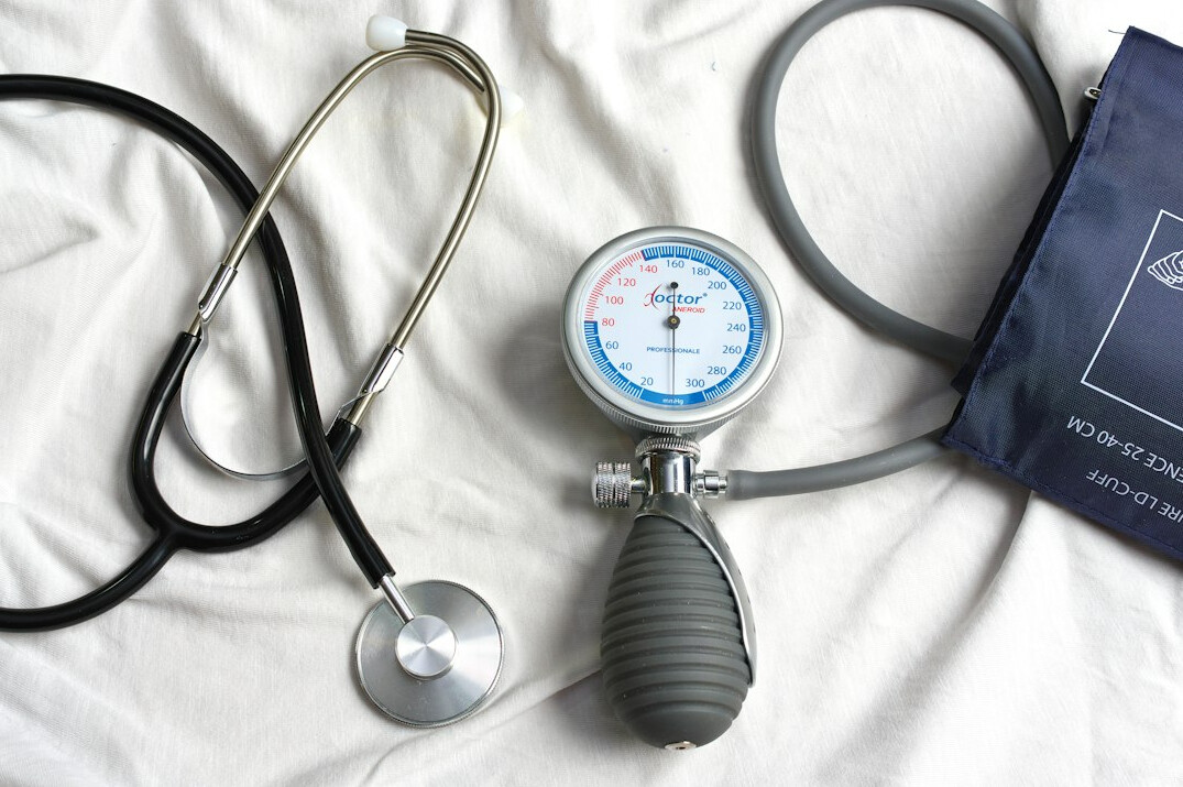 Tablet with health data dashboard next to a stethoscope