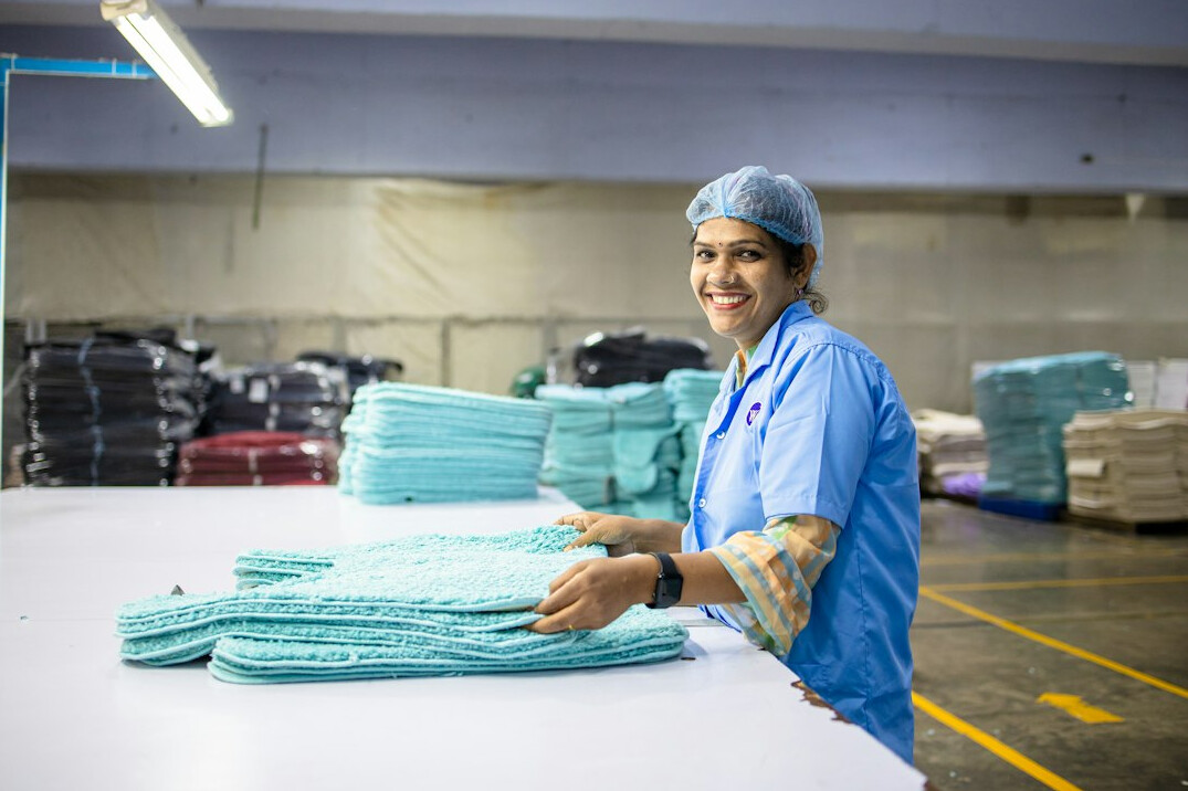 Smiling young woman nurse in blue scrubs portrait